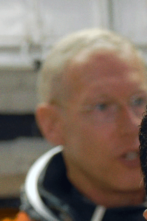 In the White Room on NASA Kennedy Space Center's Launch Pad 39A, STS-128 Mission Specialist Jose Hernandez waits his turn to enter space shuttle Discovery. In the background are Mission Specialists Patrick Forrester (left) and Christer Fuglesang (back to camera). Photo credit: NASA/Jim Grossmann