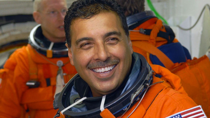 In the White Room on NASA Kennedy Space Center's Launch Pad 39A, STS-128 Mission Specialist Jose Hernandez waits his turn to enter space shuttle Discovery. In the background are Mission Specialists Patrick Forrester (left) and Christer Fuglesang (back to camera). Photo credit: NASA/Jim Grossmann