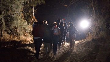 Immigrant walk up from the bank of the Rio Grande after being smuggled into the United States on April 15, 2021 in Roma, Texas. Photo by John Moore/Getty Images