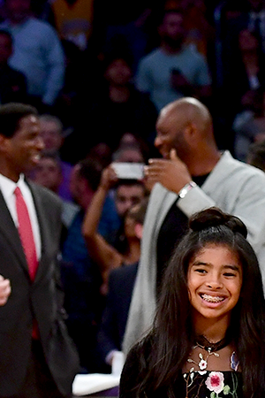 Kobe Bryant poses with his family at halftime after both his #8 and #24 Los Angeles Lakers jerseys are retired at Staples Center on December 18, 2017 in Los Angeles, California. Photo by Harry How/Getty Images
