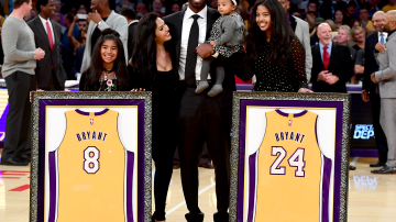 Kobe Bryant poses with his family at halftime after both his #8 and #24 Los Angeles Lakers jerseys are retired at Staples Center on December 18, 2017 in Los Angeles, California. Photo by Harry How/Getty Images