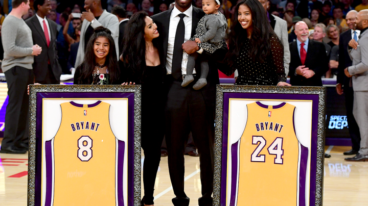 Kobe Bryant poses with his family at halftime after both his #8 and #24 Los Angeles Lakers jerseys are retired at Staples Center on December 18, 2017 in Los Angeles, California. Photo by Harry How/Getty Images