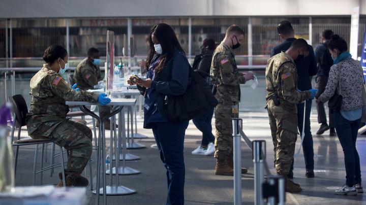 Members of the National Guard check people in at a COVID-19 vaccination site at the Javits Center in New York, United States, April 6, 2021. U.S. Xinhua/Michael Nagle via Getty Images