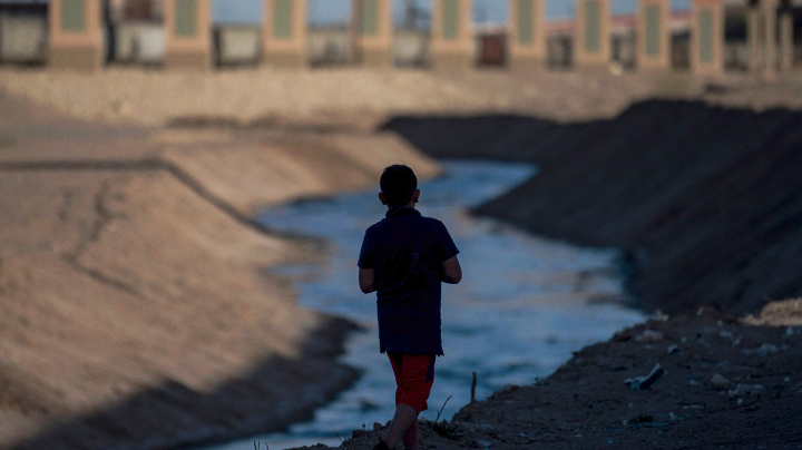 boy walks along the Rio Bravo in Ciudad Juarez, in the Mexican state of Chihuahua, across the border with El Paso, in the US state of Texas, on March 22, 2021. Photo by PEDRO PARDO/AFP via Getty Images