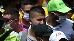 People hold a sign reading Democracy is not in quarantine during protest against a tax reform bill they say will leave them poorer as the country battles its deadliest phase yet of the coronavirus pandemic, in Cali, Colombia, on May 1, 2021. Photo by LUIS ROBAYO/AFP via Getty Images
