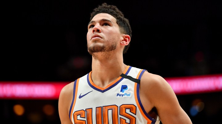 Devin Booker #1 of the Phoenix Suns looks on during the first half of the game against the Portland Trail Blazers at the Moda Center on March 10, 2020 in Portland, Oregon. Photo by Alika Jenner/Getty Images