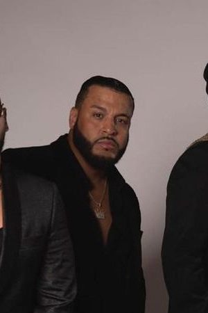 Bad Bunny and Aventura posing together.