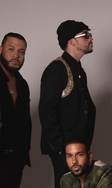 Bad Bunny and Aventura posing together.