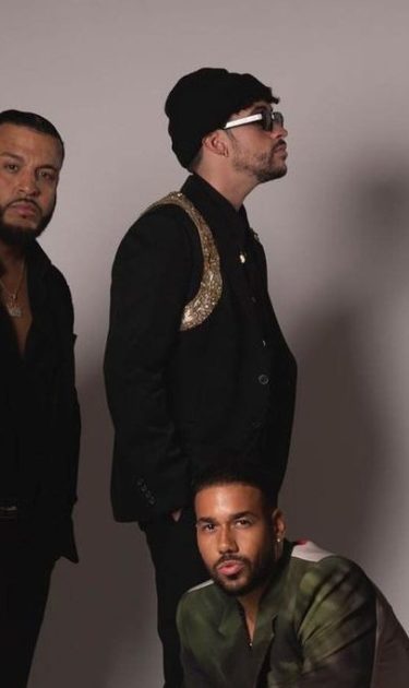 Bad Bunny and Aventura posing together.