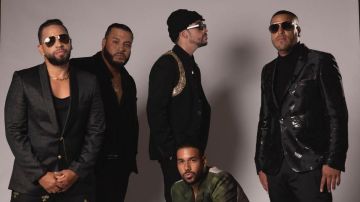 Bad Bunny and Aventura posing together.