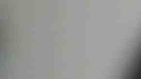 Unrecognizable black woman uses smart phone while sitting in chair in living room