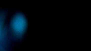 African-American couple wearing protective face masks while watching a movie at the cinema and enjoying.