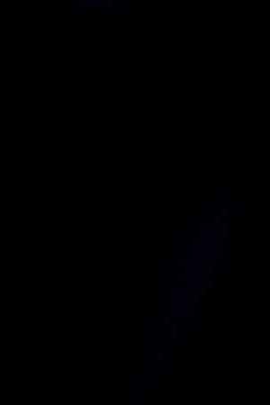 African-American couple wearing protective face masks while watching a movie at the cinema and enjoying.