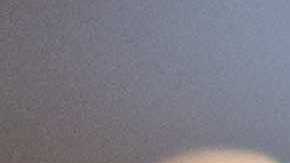 Over-the-shoulder view of a man using a computer while working an IT support job.