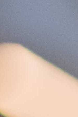 Over-the-shoulder view of a man using a computer while working an IT support job.