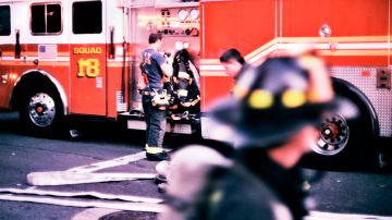 A group of New York City firefighters ready themselves for duty.