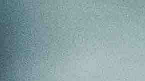 Cropped shot of young Asian woman taking a break from technology, relaxing and reading book on the sofa at a cozy home in the evening