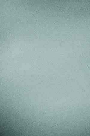 Cropped shot of young Asian woman taking a break from technology, relaxing and reading book on the sofa at a cozy home in the evening