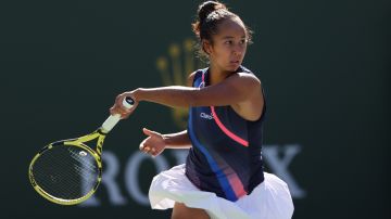 INDIAN WELLS, CALIFORNIA - OCTOBER 12: Leylah Fernandez of Canada plays a forehand against Shelby Rogers of the United States during fourth round match on Day 9 of the BNP Paribas Open at the Indian Wells Tennis Garden on October 12, 2021 in Indian Wells, California.