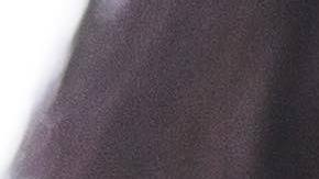 Midsection of working mother using technologies while daughter sitting in background at dining table