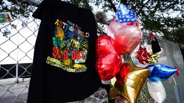 HOUSTON, TX - NOVEMBER 07: A t-shirt and balloons are placed at a memorial outside of the canceled Astroworld festival at NRG Park on November 7, 2021 in Houston, Texas. According to authorities, eight people died and 17 people were transported to local hospitals after what was described as a crowd surge at the Astroworld festival, a music festival started by Houston-native rapper and musician Travis Scott in 2018.