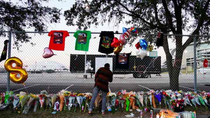 HOUSTON, TX - NOVEMBER 07: A visitor writes a note at a memorial outside of the canceled Astroworld festival at NRG Park on November 7, 2021 in Houston, Texas. According to authorities, eight people died and 17 people were transported to local hospitals after what was described as a crowd surge at the Astroworld festival, a music festival started by Houston-native rapper and musician Travis Scott in 2018.