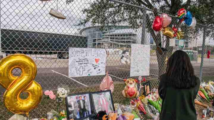 HOUSTON, TEXAS - NOVEMBER 09: A woman views a memorial dedicated to those who died at the Astroworld festival outside of NRG Park on November 09, 2021 in Houston, Texas. Eight people were killed and dozens injured last Friday in a crowd surge during a Travis Scott concert at the Astroworld music festival. Several lawsuits have been filed against Scott, and authorities continue investigations around the event. Scott, a Houston-native rapper and musician, launched the festival in 2018.