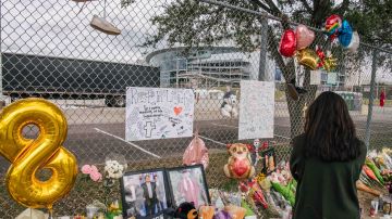 HOUSTON, TEXAS - NOVEMBER 09: A woman views a memorial dedicated to those who died at the Astroworld festival outside of NRG Park on November 09, 2021 in Houston, Texas. Eight people were killed and dozens injured last Friday in a crowd surge during a Travis Scott concert at the Astroworld music festival. Several lawsuits have been filed against Scott, and authorities continue investigations around the event. Scott, a Houston-native rapper and musician, launched the festival in 2018.
