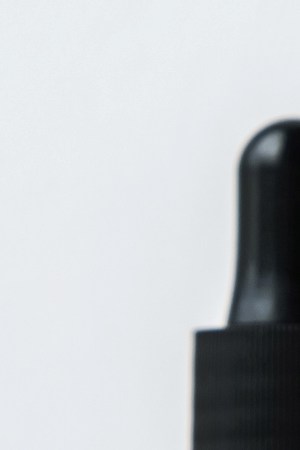 Cannabis CBD oil extracts in jars herb and small beautiful cones. Concept medical marijuana on white background