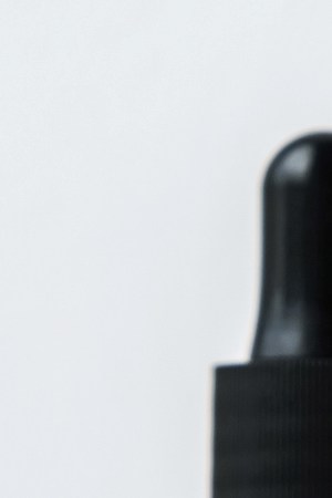 Cannabis CBD oil extracts in jars herb and small beautiful cones. Concept medical marijuana on white background