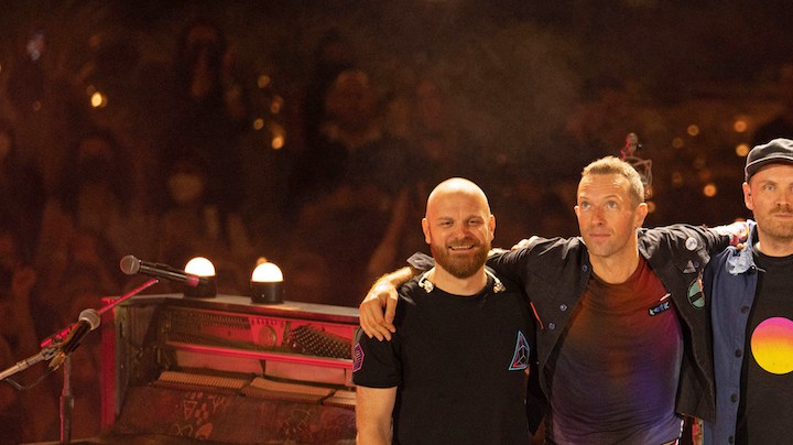 DUBAI, UNITED ARAB EMIRATES - FEBRUARY 15: Will Champion, Chris Martin, Jonny Buckland and Guy Berryman of Coldplay perform live on stage at Al Wasl Plaza on February 15, 2022 in Dubai, United Arab Emirates. (Photo by Shlomi Pinto/Getty Images)