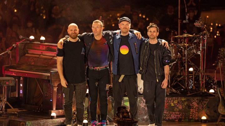 DUBAI, UNITED ARAB EMIRATES - FEBRUARY 15: Will Champion, Chris Martin, Jonny Buckland and Guy Berryman of Coldplay perform live on stage at Al Wasl Plaza on February 15, 2022 in Dubai, United Arab Emirates. (Photo by Shlomi Pinto/Getty Images)