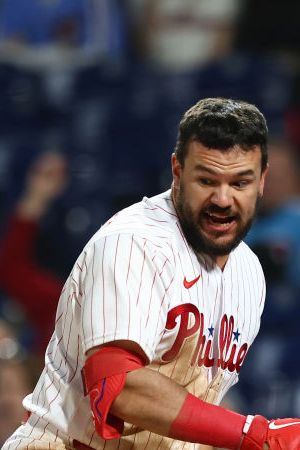 PHILADELPHIA, PA - APRIL 24: Kyle Schwarber #12 of the Philadelphia Phillies argues with home plate umpire Angel Hernandez after being called out on a third strike during the ninth inning of a game against the Milwaukee Brewers at Citizens Bank Park on April 24, 2022 in Philadelphia, Pennsylvania. The Brewers defeated the Phillies 1-0. (Photo by Rich Schultz/Getty Images)