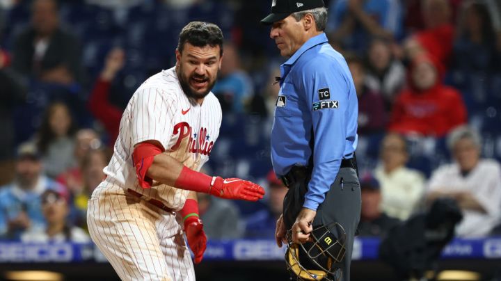PHILADELPHIA, PA - APRIL 24: Kyle Schwarber #12 of the Philadelphia Phillies argues with home plate umpire Angel Hernandez after being called out on a third strike during the ninth inning of a game against the Milwaukee Brewers at Citizens Bank Park on April 24, 2022 in Philadelphia, Pennsylvania. The Brewers defeated the Phillies 1-0. (Photo by Rich Schultz/Getty Images)