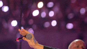 DUBAI, UNITED ARAB EMIRATES - FEBRUARY 15: Will Champion and Chris Martin of Coldplay perform live on stage at Al Wasl Plaza on February 15, 2022 in Dubai, United Arab Emirates. (Photo by Shlomi Pinto/Getty Images)