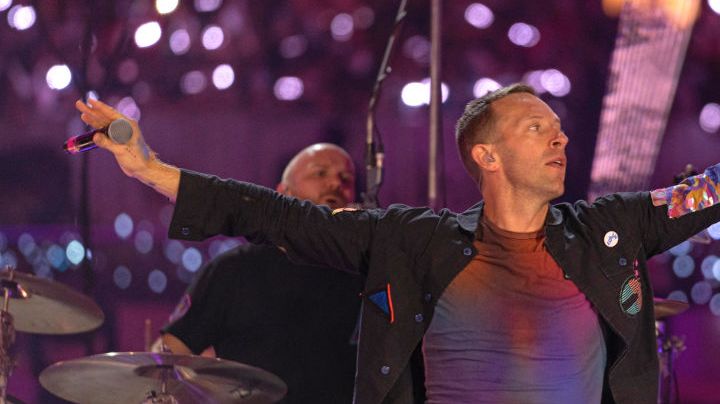 DUBAI, UNITED ARAB EMIRATES - FEBRUARY 15: Will Champion and Chris Martin of Coldplay perform live on stage at Al Wasl Plaza on February 15, 2022 in Dubai, United Arab Emirates. (Photo by Shlomi Pinto/Getty Images)