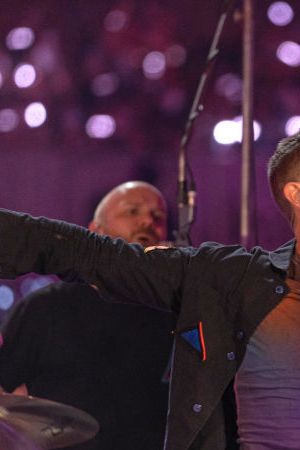 DUBAI, UNITED ARAB EMIRATES - FEBRUARY 15: Will Champion and Chris Martin of Coldplay perform live on stage at Al Wasl Plaza on February 15, 2022 in Dubai, United Arab Emirates. (Photo by Shlomi Pinto/Getty Images)