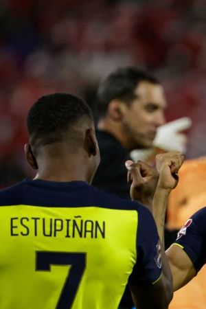 Ecuador's Pervis Estupinan (L) celebrates with teammate Byron Castillo after scoring against Chile during their South American qualification football match for the FIFA World Cup Qatar 2022 at the San Carlos de Apoquindo stadium in Santiago, on November 16, 2021. (Photo by ALBERTO VALDES / POOL / AFP) (Photo by ALBERTO VALDES/POOL/AFP via Getty Images)