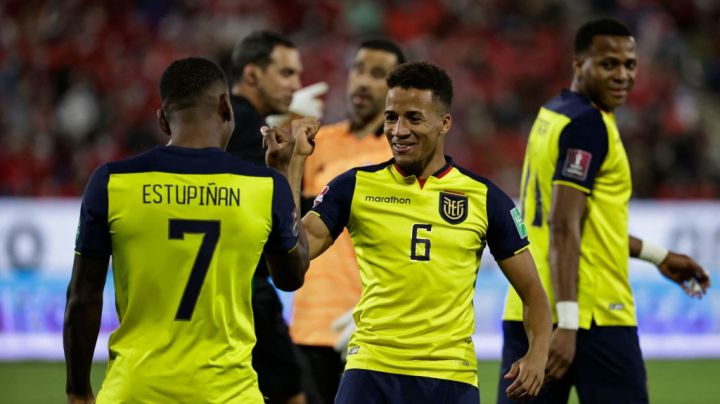 Ecuador's Pervis Estupinan (L) celebrates with teammate Byron Castillo after scoring against Chile during their South American qualification football match for the FIFA World Cup Qatar 2022 at the San Carlos de Apoquindo stadium in Santiago, on November 16, 2021. (Photo by ALBERTO VALDES / POOL / AFP) (Photo by ALBERTO VALDES/POOL/AFP via Getty Images)