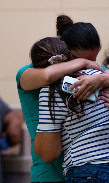 UVALDE, TEXAS - MAY 24: People mourn outside of the SSGT Willie de Leon Civic Center following the mass shooting at Robb Elementary School on May 24, 2022 in Uvalde, Texas. According to reports, 19 students and 2 adults were killed, with the gunman fatally shot by law enforcement. (Photo by Brandon Bell/Getty Images)