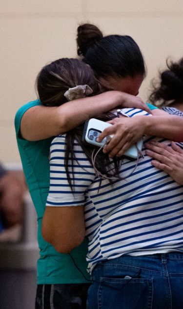 UVALDE, TEXAS - MAY 24: People mourn outside of the SSGT Willie de Leon Civic Center following the mass shooting at Robb Elementary School on May 24, 2022 in Uvalde, Texas. According to reports, 19 students and 2 adults were killed, with the gunman fatally shot by law enforcement. (Photo by Brandon Bell/Getty Images)