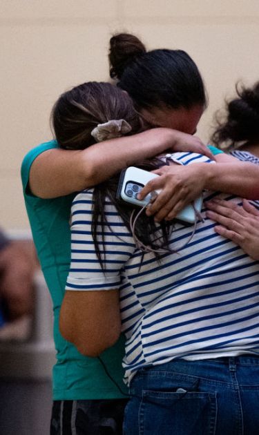 UVALDE, TEXAS - MAY 24: People mourn outside of the SSGT Willie de Leon Civic Center following the mass shooting at Robb Elementary School on May 24, 2022 in Uvalde, Texas. According to reports, 19 students and 2 adults were killed, with the gunman fatally shot by law enforcement. (Photo by Brandon Bell/Getty Images)