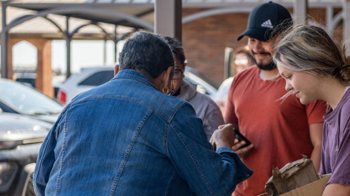 Uvalde community members distribute food to people waiting to donate blood at the South Texas Blood Bank's emergency blood drive on May 25, 2022.