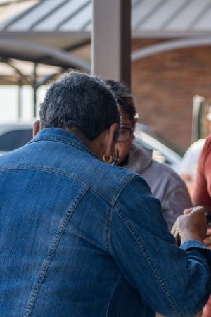 Uvalde community members distribute food to people waiting to donate blood at the South Texas Blood Bank's emergency blood drive on May 25, 2022.