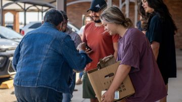 Uvalde community members distribute food to people waiting to donate blood at the South Texas Blood Bank's emergency blood drive on May 25, 2022.