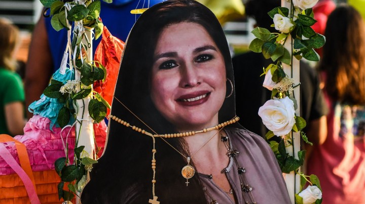 A photo of Irma Garcia, 48, who died in the mass shooting, is placed at a makeshift memorial at Robb Elementary School in Uvalde, Texas, on May 30, 2022. - Grieving families were to hold the first funerals Tuesday for Texas shooting victims one week after a school massacre left 19 children and two teachers dead, with President Joe Biden vowing to push for stricter US gun regulation. Mourners attended wakes in the town of Uvalde on Monday for some of the child victims gunned down by a local 18-year-old man who was then killed by police. (Photo by CHANDAN KHANNA / AFP) (Photo by CHANDAN KHANNA/AFP via Getty Images)