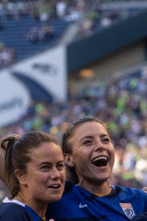 SEATTLE, WA - AUGUST 29: OL Reign Lauren Barnes #3, Sofia Huerta #11, Jessica Fishlock #10 and Megan Rapinoe #15 celebrate after a game between Portland Thorns FC and OL Reign at Lumen Field on August 29, 2021 in Seattle, Washington. (Photo by Stephen Brashear/ISI Photos/Getty Images)