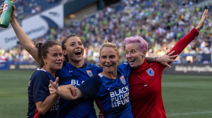 SEATTLE, WA - AUGUST 29: OL Reign Lauren Barnes #3, Sofia Huerta #11, Jessica Fishlock #10 and Megan Rapinoe #15 celebrate after a game between Portland Thorns FC and OL Reign at Lumen Field on August 29, 2021 in Seattle, Washington. (Photo by Stephen Brashear/ISI Photos/Getty Images)