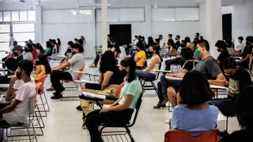 CANCUN, MEXICO - AUGUST 29: Students sit in a classroom as wait to take their entrance exam during an admission exam at CBTIS 111 on August 29, 2020 in Cancun, Mexico. Over 15,000 students sat for their high school admission exams of Quintana Roo. (Photo by Medios y Media/Getty Images)