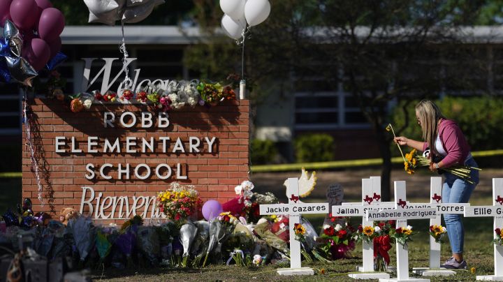 People drop off flowers at a makeshift memorial outside the Robb Elementary School on May 26, 2022 in Uvalde, Texas. - Grief at the massacre of 19 children at the elementary school in Texas spilled into confrontation on May 25, as angry questions mounted over gun control -- and whether this latest tragedy could have been prevented. The tight-knit Latino community of Uvalde on May 24 became the site of the worst school shooting in a decade, committed by a disturbed 18-year-old armed with a legally bought assault rifle. (Photo by allison dinner / AFP) (Photo by ALLISON DINNER/AFP via Getty Images)